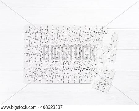 Unfinished bold jigsaw puzzle on wooden table