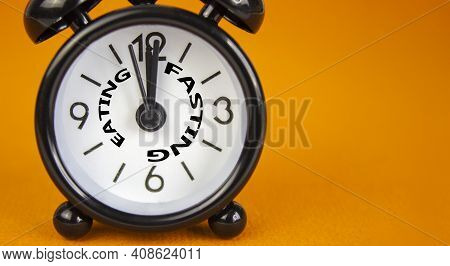 Time To Fasting Symbol. Beautiful Black Alarm Clock With Words 'eating Fasting'. Beautiful Orange Ba