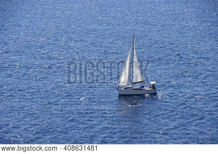 Sailingboat With White Sails At Opened Sea