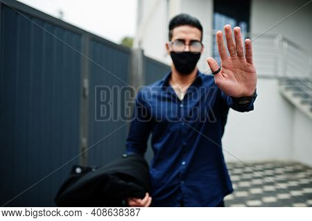 Middle Eastern Entrepreneur Wear Black Face Mask And Eyeglasses Show Stop Sign By Hand. New Normal L