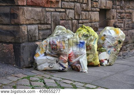 Witten, Germany - September 16, 2020: Sorted Household Waste In Yellow Bags Waiting For Pick Up In D