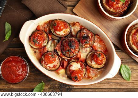 Baked Eggplant With Tomatoes, Cheese And Basil Served On Wooden Table, Flat Lay