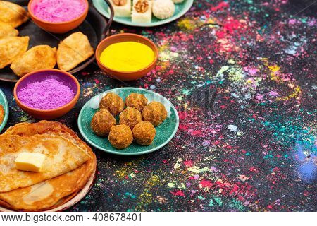 Traditional Indian Festival Food And Gulal Colors. Happy Holi Concept.