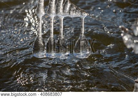 Light Reflected Through Icicles At A River In Winter Time