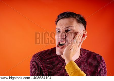 Man Getting Slapped On Orange Background. Unhappy Scared Man Getting Slapped Standing On Orange Back