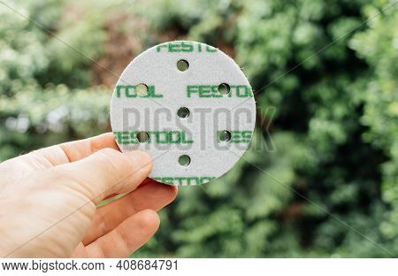 Paris, France - May 3, 2020: Pov Male Hand Holding New Interface Pad For A Sanding Machine Rotex 90 