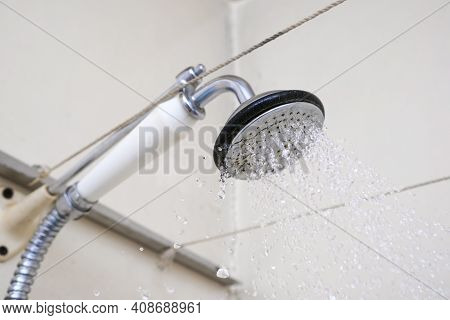 Water Flowing From An Old Shower Head With Ceramic Handle With Limescale Needed To Be Replaced Or De