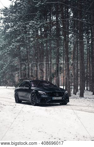 Kherson, Ukraine - February 2021. Powerful Mercedes-amg E63s Brabus 800 In A Black Color In The Wint