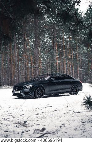 Kherson, Ukraine - February 2021. Powerful Mercedes-amg E63s Brabus 800 In A Black Color In The Wint