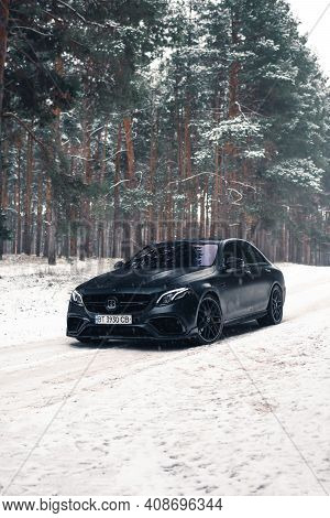Kherson, Ukraine - February 2021. Powerful Mercedes-amg E63s Brabus 800 In A Black Color In The Wint