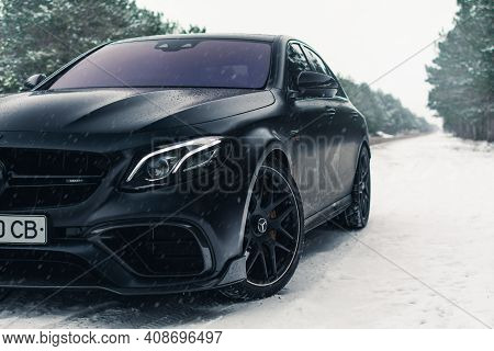 Kherson, Ukraine - February 2021. Powerful Mercedes-amg E63s Brabus 800 In A Black Color On The Empt