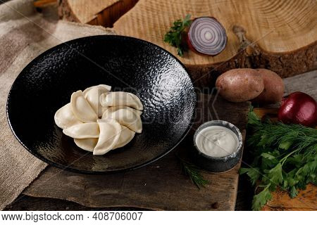 Appetizing Traditional Russian Dumplings, Hand-made With Potatoes. Still Life On A Wooden Board. Clo
