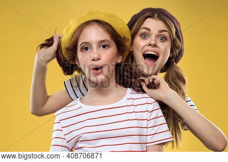 Cheerful Sisters In Hats Striped T-shirts Joy Lifestyle Yellow Background Family