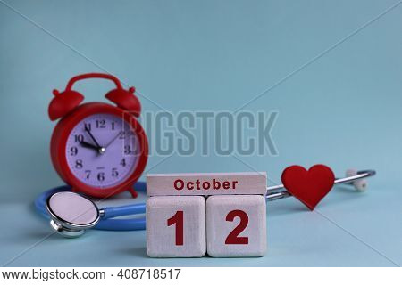 October 12. Day Of The 12th Month, Calendar Date. White Wooden Calendar Blocks With Date, Clock And 