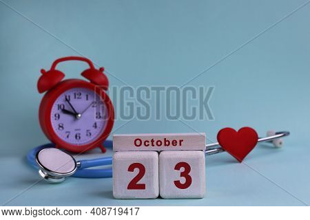 October 23. Day Of The 23th Month, Calendar Date. White Wooden Calendar Blocks With Date, Clock And 