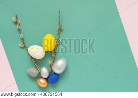 Colored Easter Eggs With Willow Branches On Color Pink And Green Background. Easter Card With Empty 
