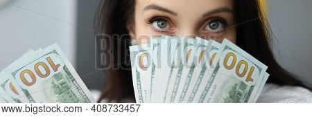 Young Businesswoman Is Holding Many American Dollars In Her Hands, Covering Her Face. Disbursement O