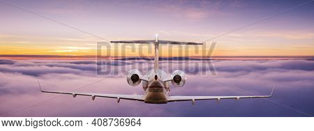 Small private jetplane flying above beautiful clouds. Travel and transportation concept.