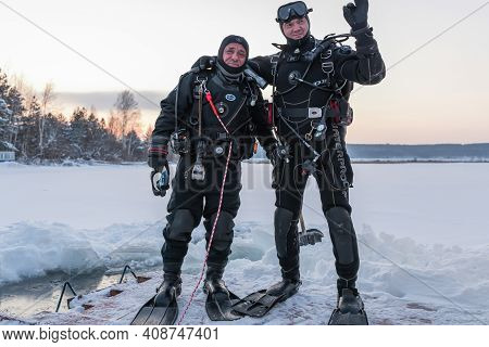 Russia, River Volga Kama - Jan 17th 2020. Two Divers Greet, Before Scuba Ice Diving. Outdoor Winter 