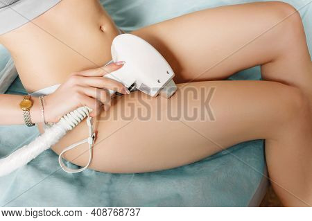 Young Woman Showing Smooth Silky Skin After Laser Epilation. Girl With A Medical Laser Maniple In Ha