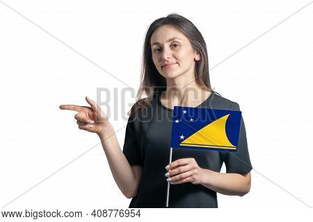 Happy Young White Woman Holding Flag Tokelau And Points To The Left Isolated On A White Background.