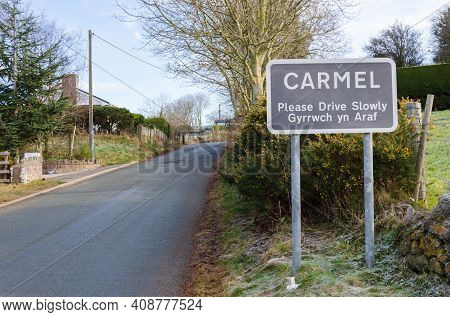 Carmel, Flintshire; Uk: Feb 11, 2021: A Place Name Sign At The Entrance To The Village Of Carmel Inc