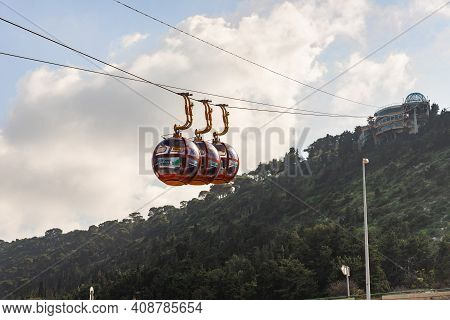 Haifa, Israel, February 13, 2021 : Cable Car Cabins Move From The Lower Station On The Waterfront To
