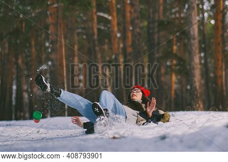 Girl Fell On The Wet Snow In The Forest. Funny Fail. The Cup Flew Out Of Hand. Be Careful On A Wet S