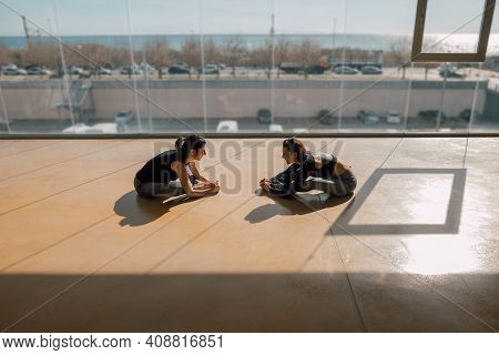 Young Adult Female Friends Enjoying Gym Training Together In A Gymnasium, Laughing And Having Fun. P