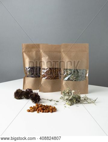 Brown Kraft Paper Doypack Bags With Dried Berries And Medical Herbs. Packaging For Foods And Goods T