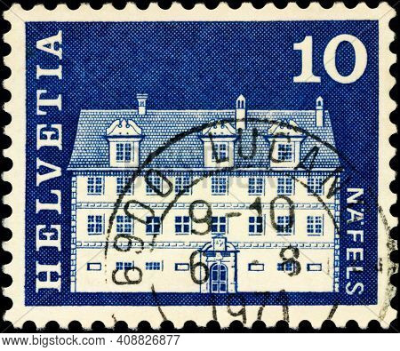 Moscow, Russia - February 15, 2021: Stamp Printed In Switzerland Shows Freuler-palace In Nafels, Can