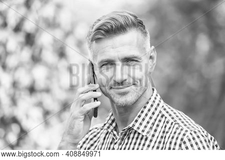 Answering A Call. Unshaven Man Talk On Cell Phone Outdoors. Taking Cell Phone Call. Mobile Or Cell P