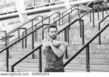 Preparing His Muscles. Fitness Man Warming Up In The Gym. Having A Good Stretch. Handsome Man In Spo