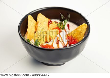 Creamy Salmon Soup In A Black Carriage. Ingredients Cream, Salmon, Vegetable Oil, Salmon Caviar, Ter