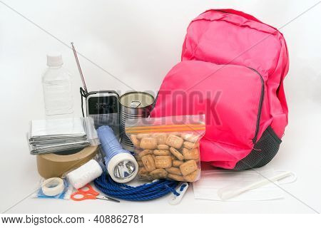 Pink Rucksack And Disaster Prevention Goods In Front Of Light Gray Background