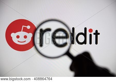 London, Uk - February 2021: Reddit Logo Seen Under A Magnifying Glass