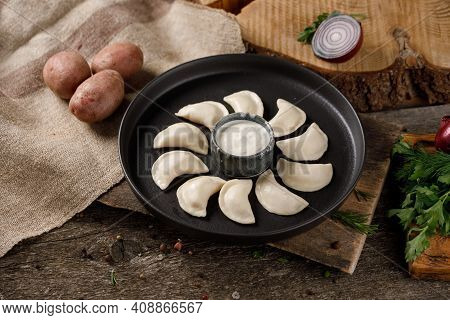 Appetizing Traditional Russian Dumplings, Hand-made With Potatoes. Still Life On A Wooden Board. Clo