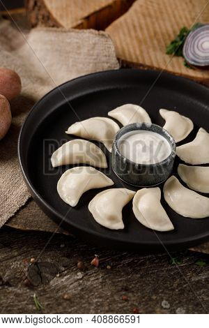Appetizing Traditional Russian Dumplings, Hand-made With Potatoes. Still Life On A Wooden Board. Clo
