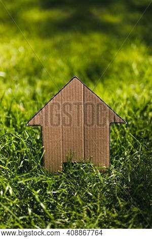 Green Home And Eco-friendly Construction, House Icon On Green Grass Lawn Under The Sun With Garden B