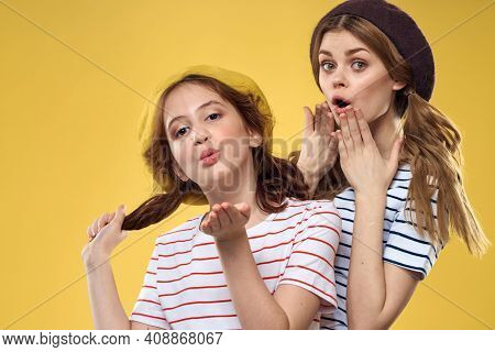 Cheerful Sisters In Hats Striped T-shirts Joy Lifestyle Yellow Background Family