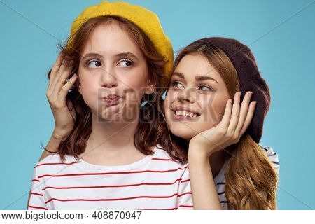 Mom And Daughter Striped T-shirts Hugs Fun Lifestyle Blue Background