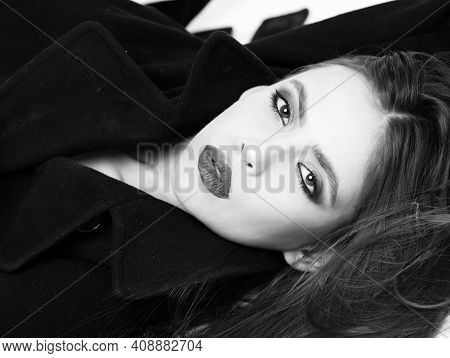 Beautiful Youg Woman, She Wears A Black Coat. Girl Has Fashionable Lips Makeup