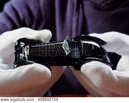 Gomel, Belarus - February 16, 2021: Portrait Of A Collector Of Retro Car Models On A Black Backgroun
