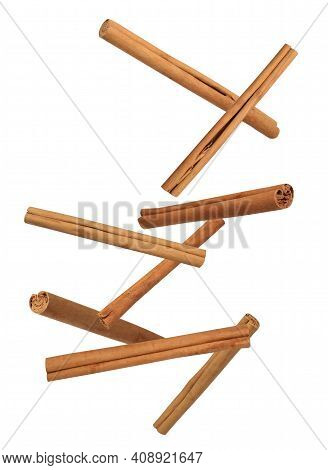 Aromatic Cinnamon Sticks Falling On White Background