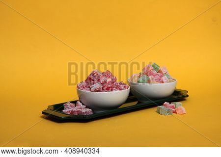 Two Bowls Of Rahat Lakoum On A Tray Isolated On Yellow Background Horizontal Image. Turkish Sweet Co