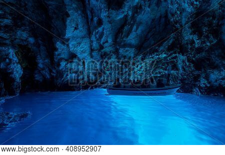 Bisevo, Croatia - Aug 16, 2020: Tourists On A Boat In Serene Blue Cave Near Komiza Island