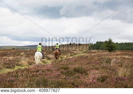Shropshire, Uk - September 08, 2013. Two People Horseback Riding On Long Mynd, Shropshire Hills, Uk