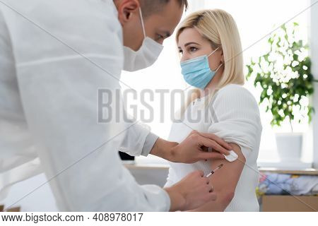 Doctor Injecting Vaccine To Woman, Covid Vaccine