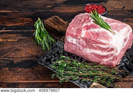 Pork Shoulder Raw Meat For Fresh Steaks On Wooden Cutting Board With Butcher Cleaver. Dark Wooden Ba