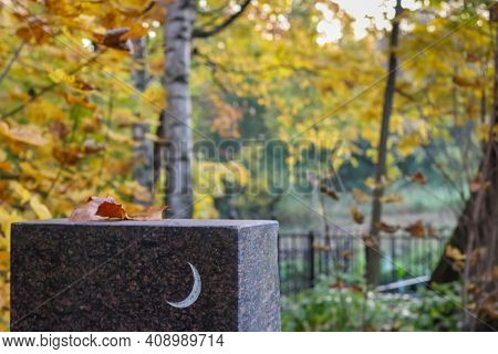 White Crescent Moon Symbol On The Grave Rectangular Granite Slab. Muslim Background